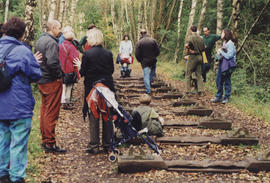 Photograph of people walking across sculpture Iron Road